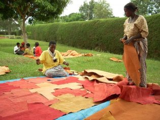 Women in Uganda sewing barkcloth pieces together. Credit: Barktex